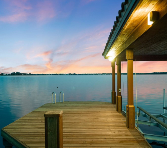 dock overlooking a body of water at sunset
